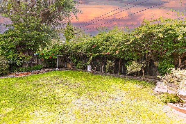 7110 SW 13th Ter, Miami, FL 33144 - yard at dusk with a fenced backyard