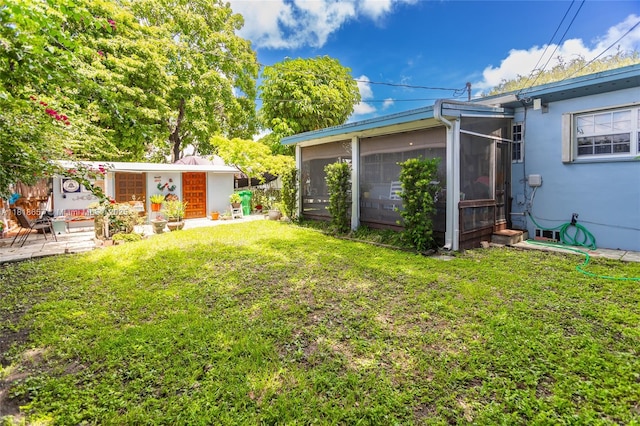 7110 SW 13th Ter, Miami, FL 33144 - view of grassy yard with a sunroom and an outbuilding