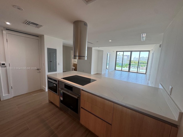 9901 W Bay Harbour Dr Unit 605, Bay Harbor Islands, FL 33154 - kitchen with oven, black electric cooktop, wood finished floors, exhaust hood, and open floor plan