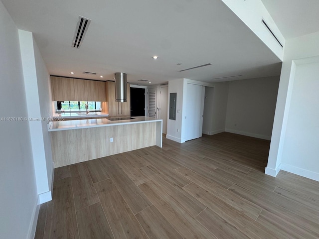 9901 W Bay Harbour Dr Unit 605, Bay Harbor Islands, FL 33154 - kitchen with modern cabinets, light countertops, wood finished floors, light brown cabinets, and recessed lighting