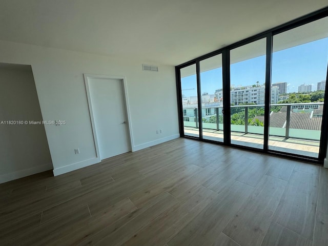 9901 W Bay Harbour Dr Unit 605, Bay Harbor Islands, FL 33154 - unfurnished room featuring expansive windows, a city view, and dark wood finished floors