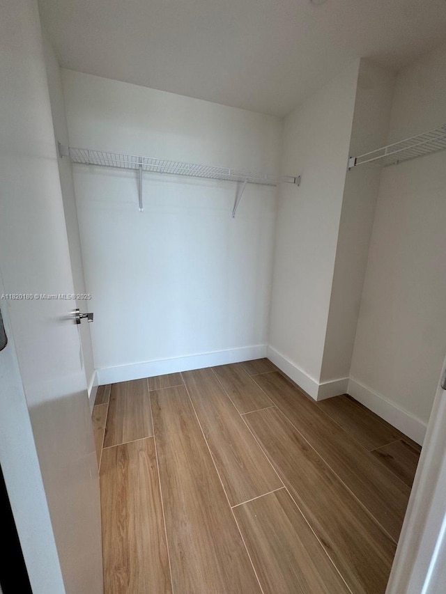 9901 W Bay Harbour Dr Unit 605, Bay Harbor Islands, FL 33154 - walk in closet with light wood-style floors