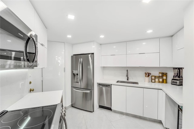 999 Brickell Bay Dr Unit 711, Miami, FL 33131 - kitchen with appliances with stainless steel finishes, modern cabinets, white cabinetry, light countertops, and recessed lighting