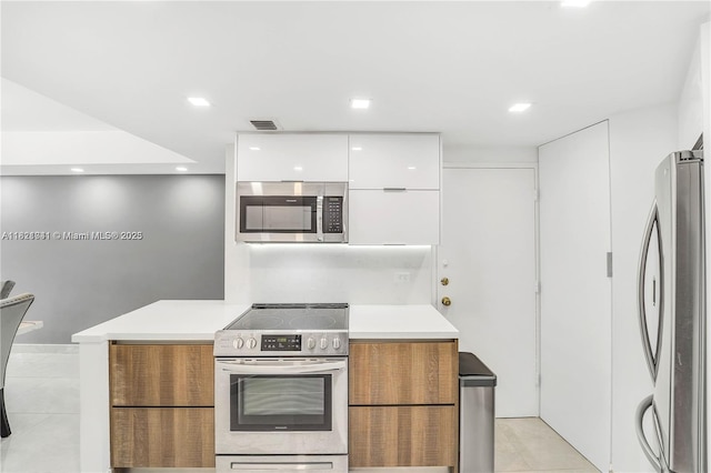 999 Brickell Bay Dr Unit 711, Miami, FL 33131 - kitchen with appliances with stainless steel finishes, modern cabinets, light tile patterned floors, white cabinets, and recessed lighting