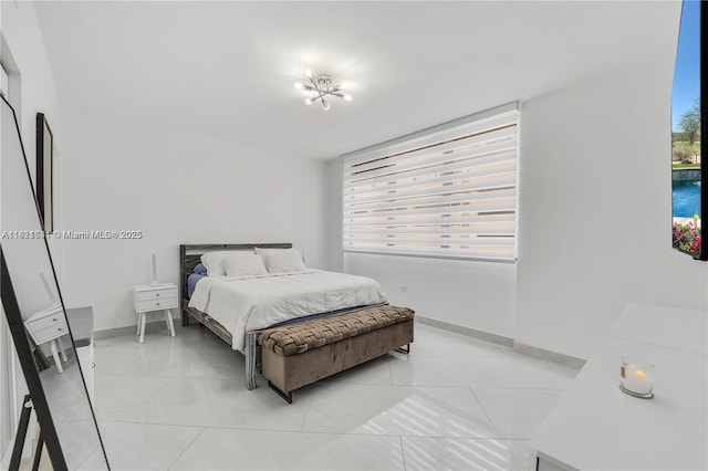 999 Brickell Bay Dr Unit 711, Miami, FL 33131 - bedroom with baseboards and light tile patterned flooring