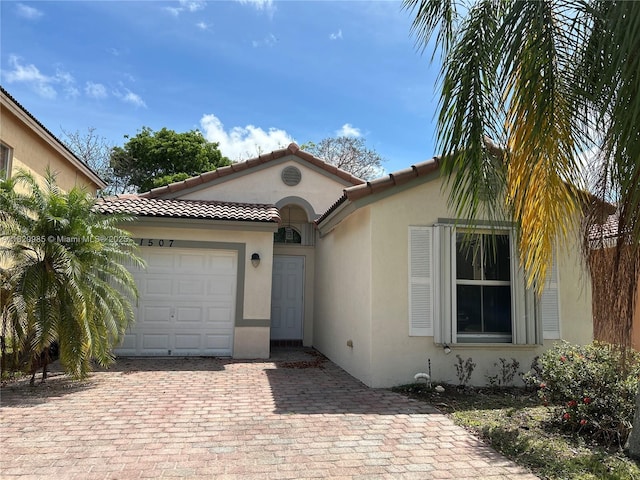 1507 SE 20th Rd, Homestead, FL 33035 - mediterranean / spanish-style home with stucco siding, a garage, decorative driveway, and a tile roof