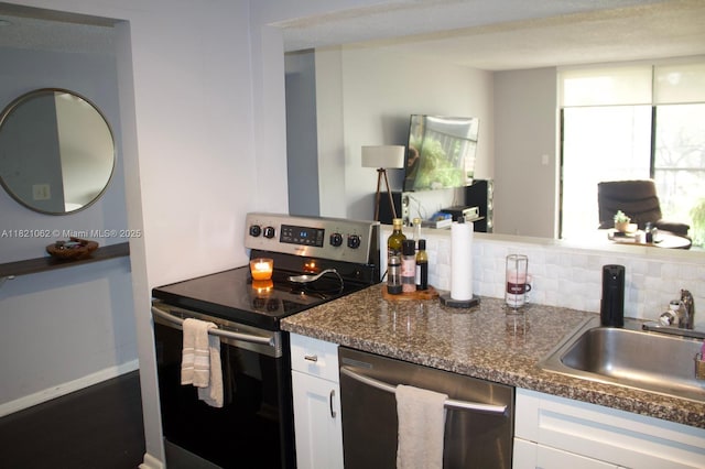 8015 SW 107th Ave Unit 220, Miami, FL 33173 - kitchen featuring stainless steel appliances, white cabinetry, backsplash, and dark stone countertops