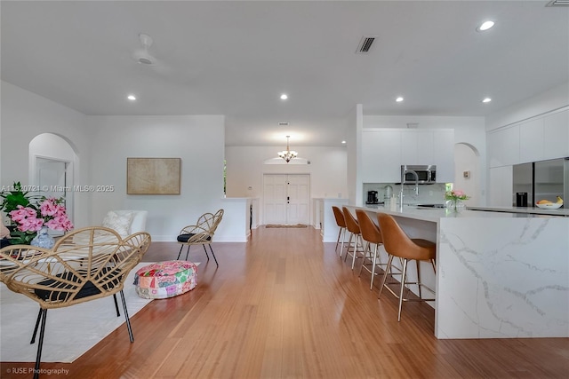 17050 SW 90th Ave, Palmetto Bay, FL 33157 - kitchen featuring appliances with stainless steel finishes, modern cabinets, white cabinetry, recessed lighting, and a kitchen breakfast bar