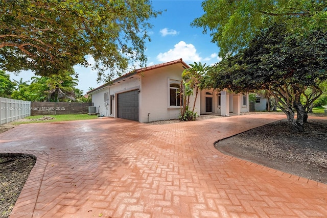 17050 SW 90th Ave, Palmetto Bay, FL 33157 - mediterranean / spanish-style home featuring decorative driveway, stucco siding, a garage, and a tile roof
