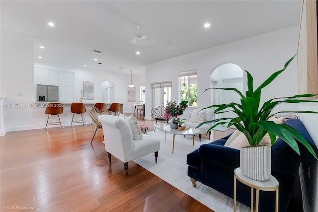 17050 SW 90th Ave, Palmetto Bay, FL 33157 - living area with light wood-style floors, recessed lighting, and arched walkways