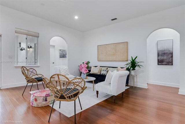 17050 SW 90th Ave, Palmetto Bay, FL 33157 - living room with arched walkways, wood finished floors, and recessed lighting