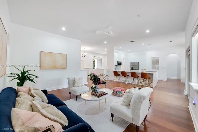 17050 SW 90th Ave, Palmetto Bay, FL 33157 - living area with arched walkways, light wood-style flooring, recessed lighting, and a chandelier