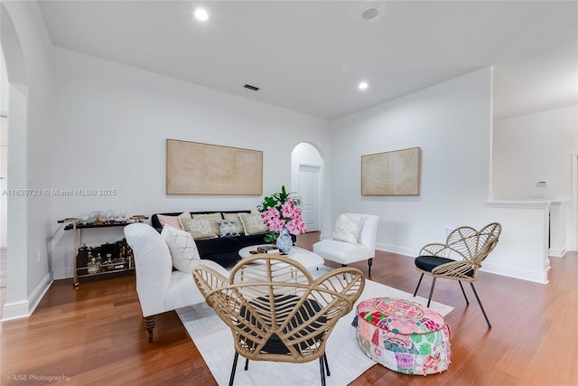 17050 SW 90th Ave, Palmetto Bay, FL 33157 - living room featuring arched walkways, wood finished floors, and recessed lighting