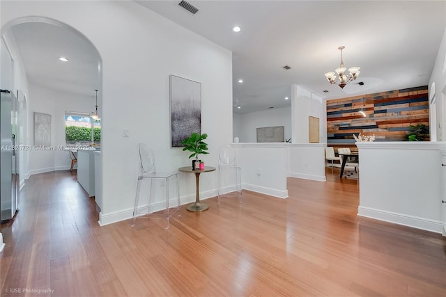 17050 SW 90th Ave, Palmetto Bay, FL 33157 - corridor with a chandelier, arched walkways, wood finished floors, recessed lighting, and an upstairs landing