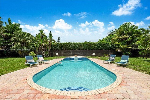17050 SW 90th Ave, Palmetto Bay, FL 33157 - view of pool featuring a patio, a fenced backyard, and a pool with connected hot tub