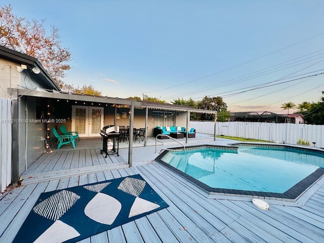 3338 Taft St, Hollywood, FL 33021 - view of pool with a fenced backyard, a wooden deck, outdoor lounge area, and french doors