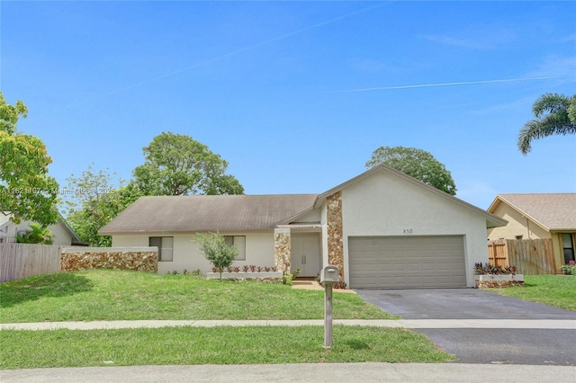 8511 NW 51st Ct, Lauderhill, FL 33351 - view of front facade with stucco siding, an attached garage, and driveway