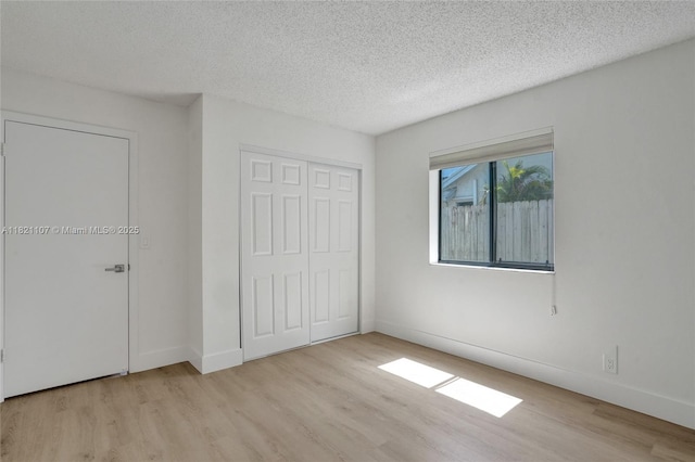 8511 NW 51st Ct, Lauderhill, FL 33351 - unfurnished bedroom with wood finished floors, a textured ceiling, and a closet