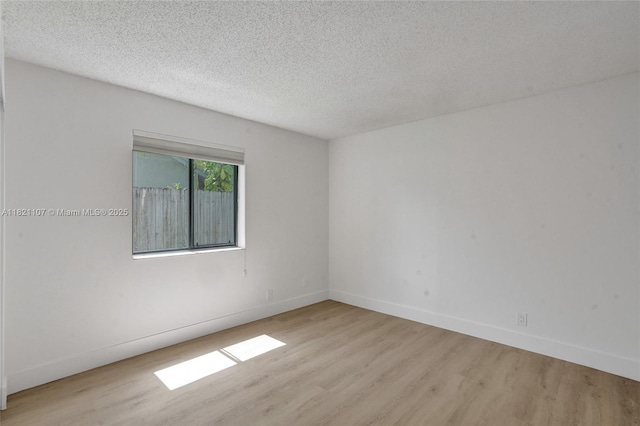 8511 NW 51st Ct, Lauderhill, FL 33351 - empty room featuring wood finished floors and a textured ceiling