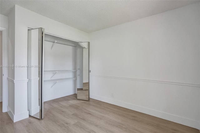 8511 NW 51st Ct, Lauderhill, FL 33351 - unfurnished bedroom with light wood-style floors, a textured ceiling, and a closet