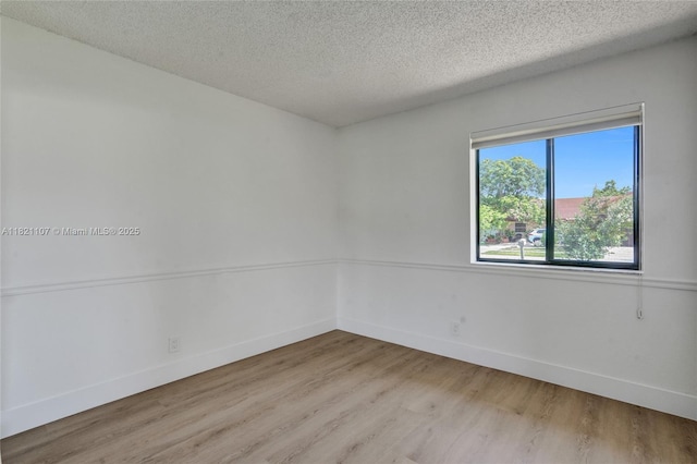 8511 NW 51st Ct, Lauderhill, FL 33351 - spare room featuring a textured ceiling and light wood-type flooring