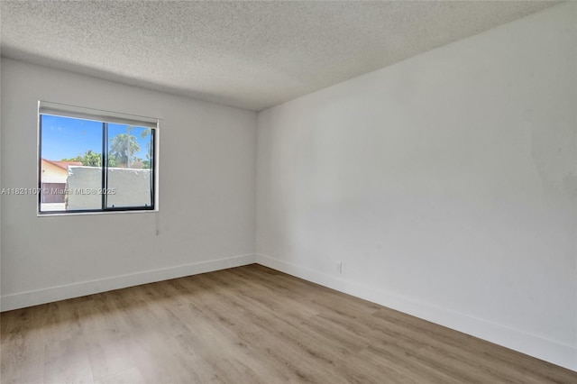 8511 NW 51st Ct, Lauderhill, FL 33351 - unfurnished room featuring wood finished floors and a textured ceiling
