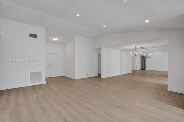 8511 NW 51st Ct, Lauderhill, FL 33351 - unfurnished living room featuring lofted ceiling, a chandelier, light wood finished floors, and recessed lighting
