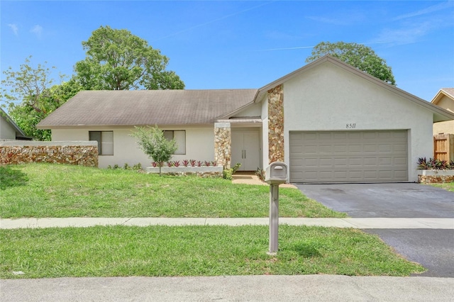 8511 NW 51st Ct, Lauderhill, FL 33351 - view of front facade featuring stucco siding, asphalt driveway, an attached garage, and a front yard