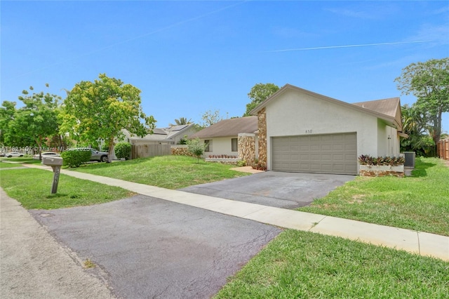 8511 NW 51st Ct, Lauderhill, FL 33351 - view of front of property with driveway, an attached garage, and stucco siding