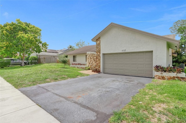 8511 NW 51st Ct, Lauderhill, FL 33351 - view of front of property with a garage, stucco siding, and asphalt driveway