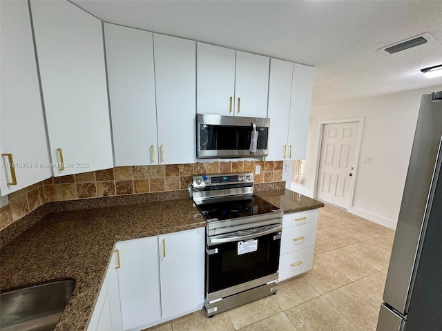 6213 NW 9th St, Margate, FL 33063 - kitchen featuring stainless steel appliances, decorative backsplash, and white cabinets