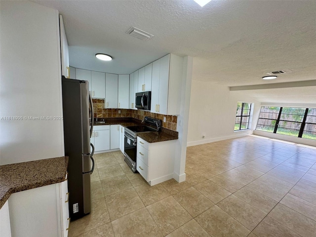 6213 NW 9th St, Margate, FL 33063 - kitchen with black electric range, freestanding refrigerator, open floor plan, decorative backsplash, and light tile patterned flooring