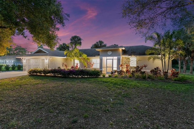 1020 SW 19th St SW, Naples, FL 34117 - ranch-style home featuring concrete driveway, a garage, stucco siding, and a front lawn