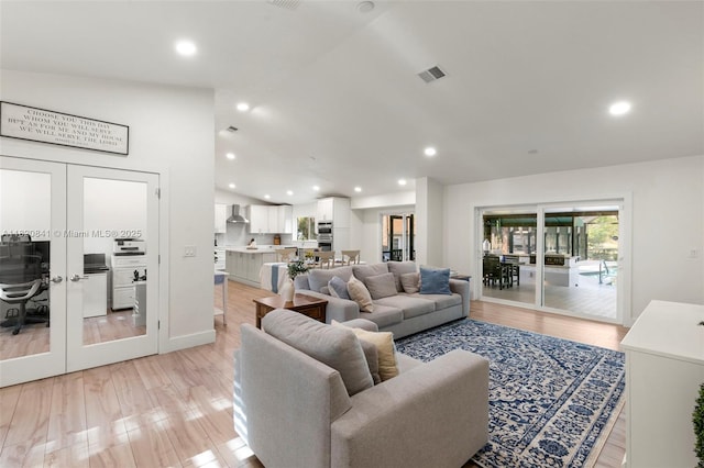 1020 SW 19th St SW, Naples, FL 34117 - living room featuring french doors, vaulted ceiling, light wood-style flooring, and recessed lighting