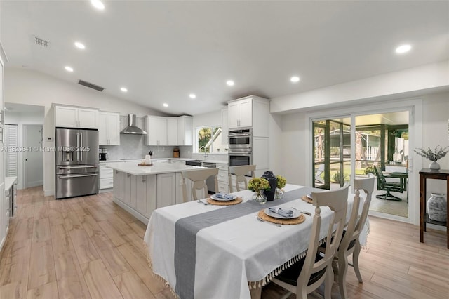 1020 SW 19th St SW, Naples, FL 34117 - dining space with light wood finished floors, vaulted ceiling, and recessed lighting