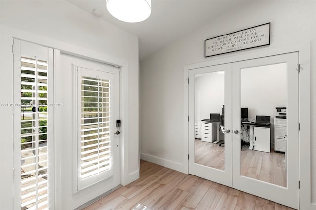 1020 SW 19th St SW, Naples, FL 34117 - doorway to outside featuring french doors, wood finished floors, a desk, and vaulted ceiling