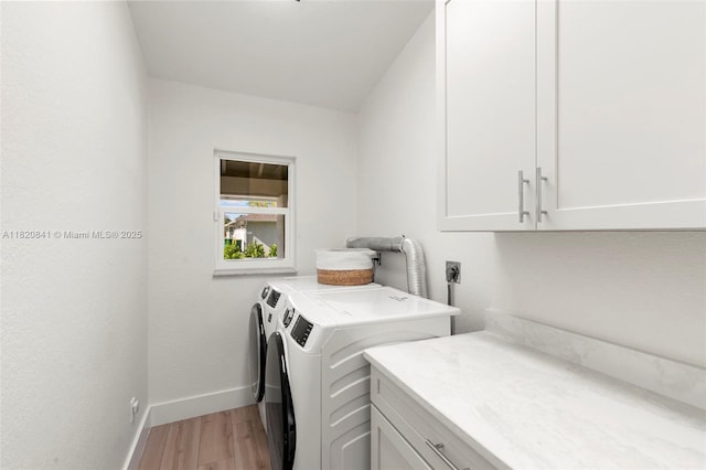1020 SW 19th St SW, Naples, FL 34117 - washroom featuring cabinet space, light wood-style floors, and washer and clothes dryer