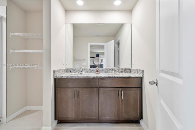5720 Mentmore Dr, Mangonia Park, FL 33407 - bathroom featuring double vanity, tile patterned floors, and recessed lighting