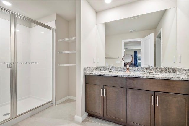 5720 Mentmore Dr, Mangonia Park, FL 33407 - full bathroom featuring double vanity, a stall shower, and tile patterned floors