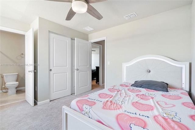 5720 Mentmore Dr, Mangonia Park, FL 33407 - bedroom featuring light carpet, a closet, ensuite bathroom, and a ceiling fan