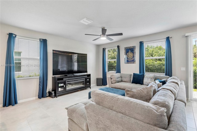 5720 Mentmore Dr, Mangonia Park, FL 33407 - living room featuring plenty of natural light, a ceiling fan, and light tile patterned flooring