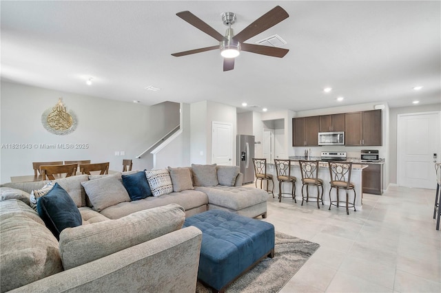 5720 Mentmore Dr, Mangonia Park, FL 33407 - living room with recessed lighting, a ceiling fan, light tile patterned flooring, and stairway