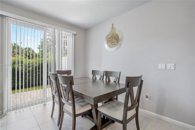 5720 Mentmore Dr, Mangonia Park, FL 33407 - dining area with baseboards and light tile patterned floors