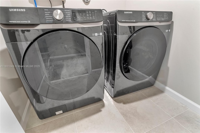 5720 Mentmore Dr, Mangonia Park, FL 33407 - laundry area featuring washing machine and clothes dryer and tile patterned floors