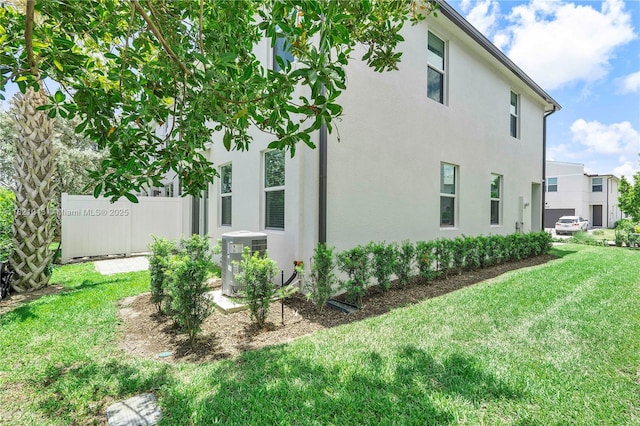 5720 Mentmore Dr, Mangonia Park, FL 33407 - view of property exterior featuring a central air condition unit and stucco siding