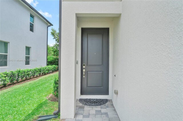 5720 Mentmore Dr, Mangonia Park, FL 33407 - entrance to property with stucco siding and a yard