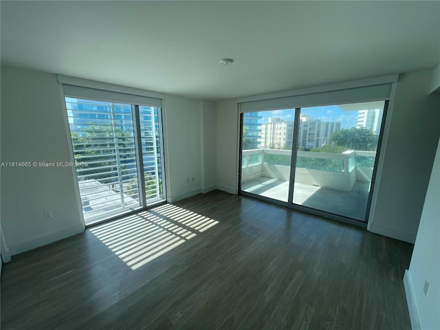 1025 92nd St Unit 607, Bay Harbor Islands, FL 33154 - spare room featuring baseboards and wood finished floors