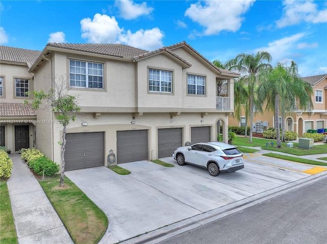 13227 SW 42nd St Unit 8103, Miramar, FL 33027 - view of property with stucco siding, a tiled roof, a garage, and driveway