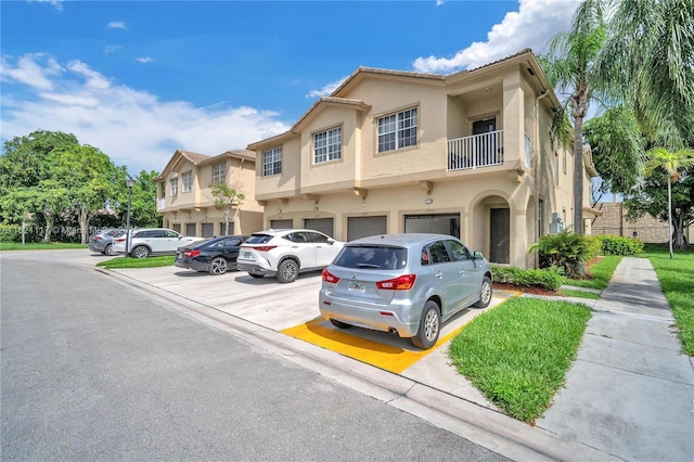 13227 SW 42nd St Unit 8103, Miramar, FL 33027 - view of property featuring a balcony, stucco siding, and uncovered parking