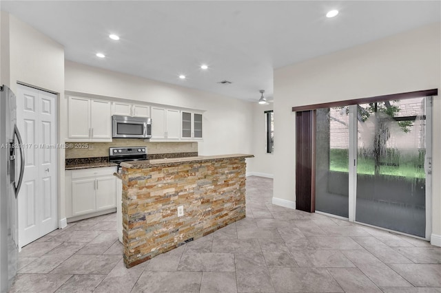 13227 SW 42nd St Unit 8103, Miramar, FL 33027 - kitchen featuring stainless steel appliances, white cabinets, backsplash, recessed lighting, and a kitchen island